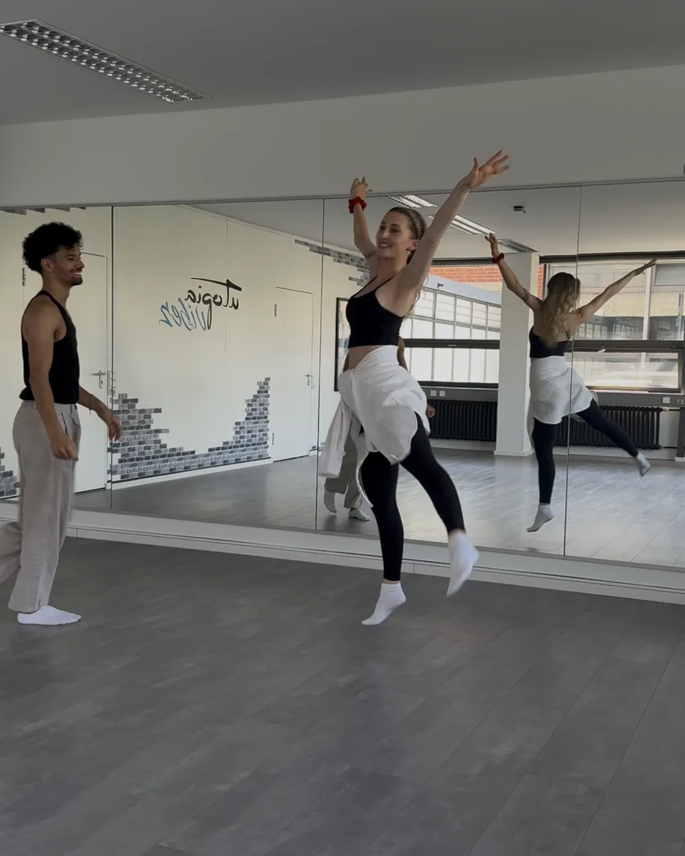 A dancer jumping for joy during rehearsal