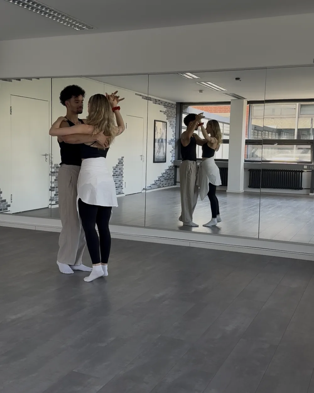 A couple rehearsing their first dance in the studio